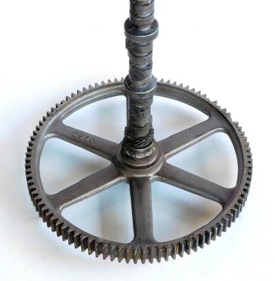 Pair of industrial cast iron gear wheel tables with circular glass tops