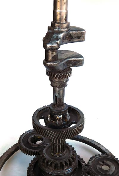 Pair of industrial cast iron gear wheel tables with circular glass tops