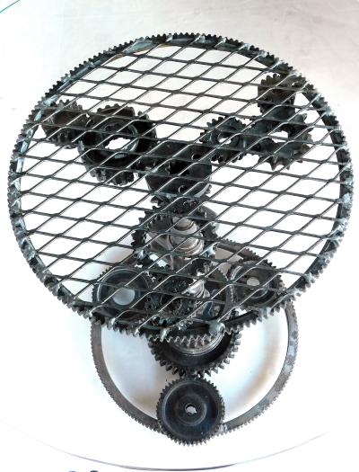 Pair of industrial cast iron gear wheel tables with circular glass tops