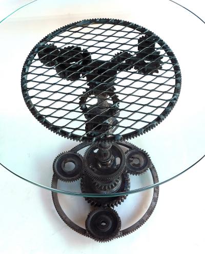 Pair of industrial cast iron gear wheel tables with circular glass tops