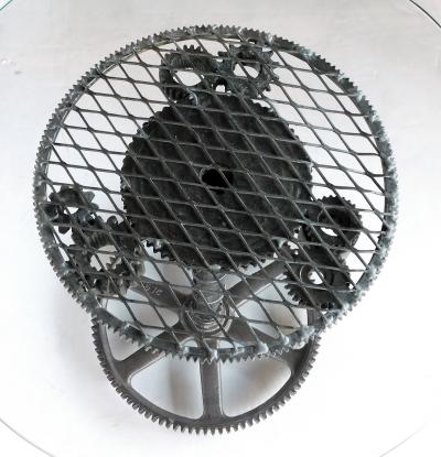 Pair of industrial cast iron gear wheel tables with circular glass tops