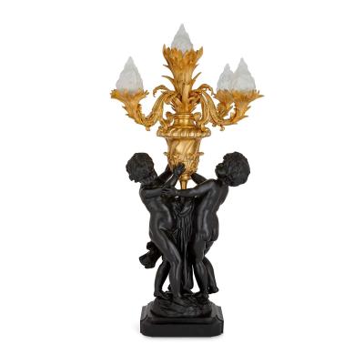 Pair of large Louis XVI style gilt and patinated bronze cherub candelabra