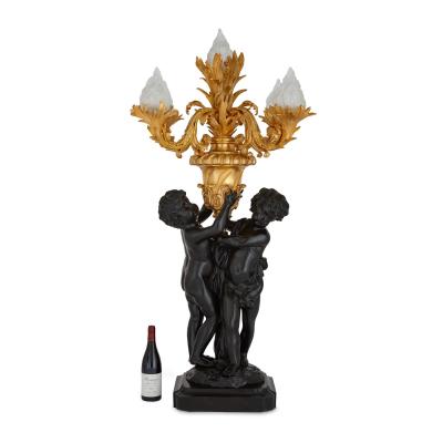 Pair of large Louis XVI style gilt and patinated bronze cherub candelabra