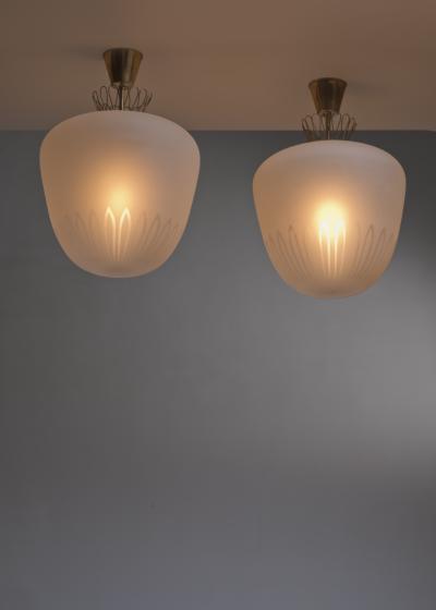 Pair of large frosted glass and brass pendants
