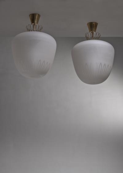 Pair of large frosted glass and brass pendants
