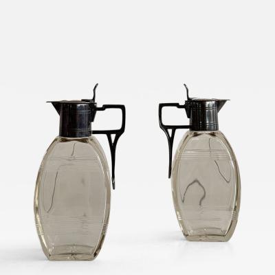 Pair of lidded carafes circa 1910