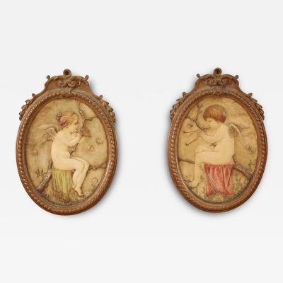 Pair of oval terracotta cherubs from the 20th century