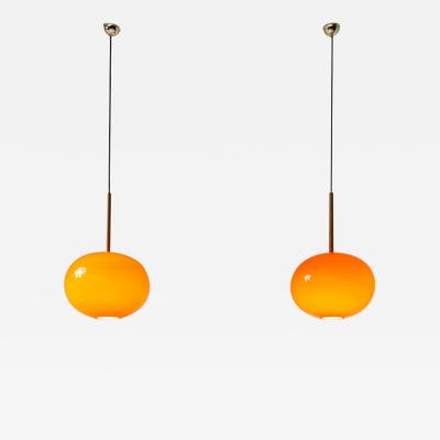 Pair of pendant chandeliers with wooden stem and red blown glass diffuser