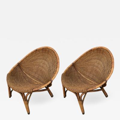 Pair of rattan oeuf shaped lounge chairs with brass leg end