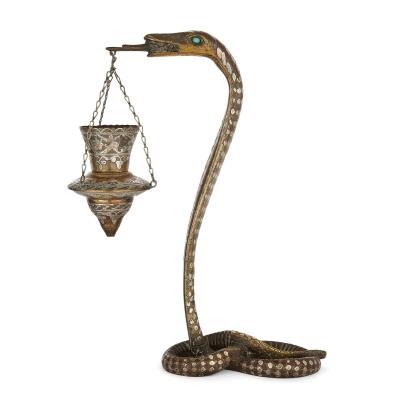 Pair of silver inlaid brass Art Deco serpent candle holders