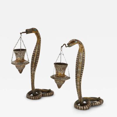 Pair of silver inlaid brass Art Deco serpent candle holders