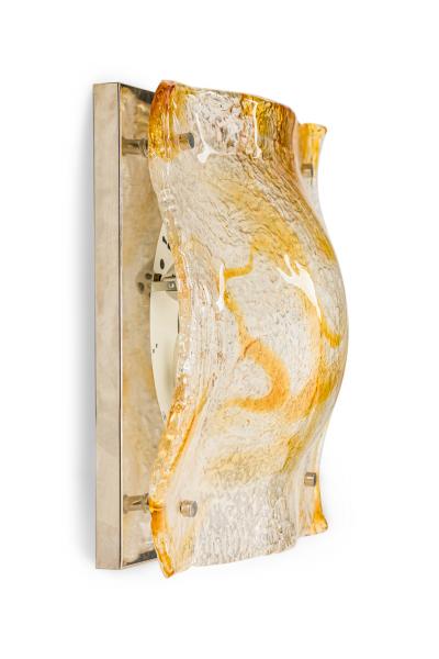 Pair of textured clear and amber glass sconces with a half round freeform design