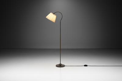 Patinated Brass Floor Lamp with Curved Neck Europe 20th century