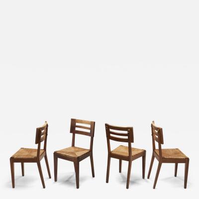 Pierre Cru ge A Set of Four Dining Chairs with Woven Seats by Pierre Cru ge France ca 1950s