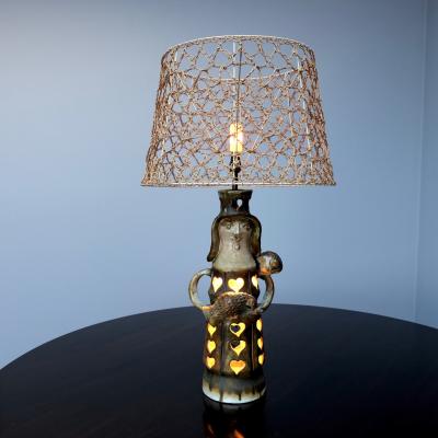 Pottery lamp with heart motif with original string shade