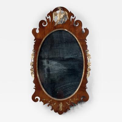 RARE OVAL CHIPPENDALE LOOKING GLASS WITH AN INSET CARVED PHOENIX