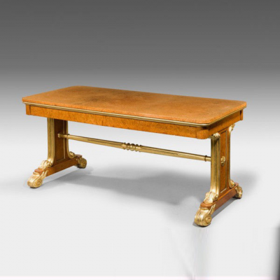 Regency Amboyna and parcel gilt end support library table