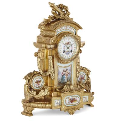 Rococo style gilt bronze mantel clock with S vres style porcelain plaques