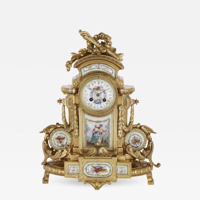 Rococo style gilt bronze mantel clock with S vres style porcelain plaques