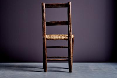 Rustic ladder back chair with straw seat