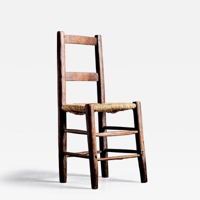 Rustic ladder back chair with straw seat