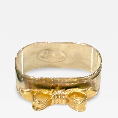 SET OF EIGHT SIVERPLATE GOLDTONE BOW DESIGN NAPKIN RINGS