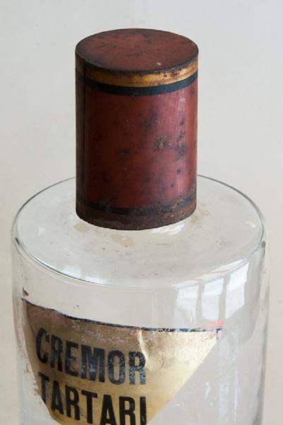 SET OF FOUR HAND BLOWN GLASS APOTHECARY BOTTLES WITH GILT AND RED TOPS