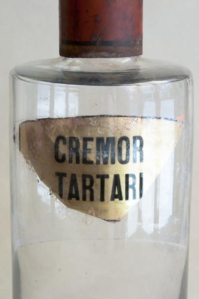 SET OF FOUR HAND BLOWN GLASS APOTHECARY BOTTLES WITH GILT AND RED TOPS