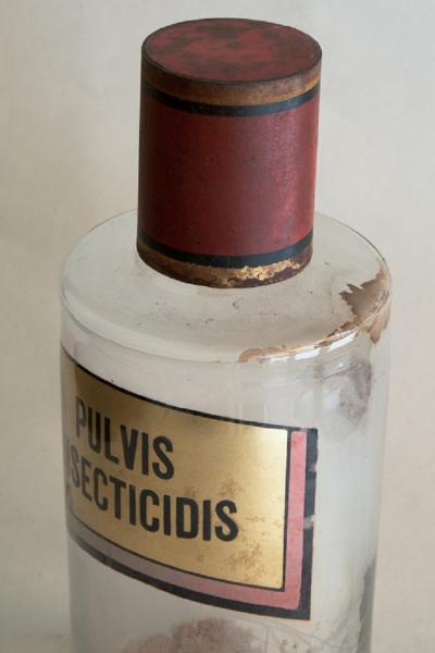 SET OF FOUR HAND BLOWN GLASS APOTHECARY BOTTLES WITH GILT AND RED TOPS