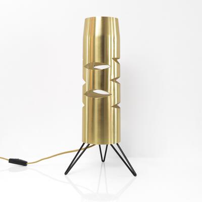 Scandinavian Modern cylindrical brass lamp with cutouts on a tripod base 