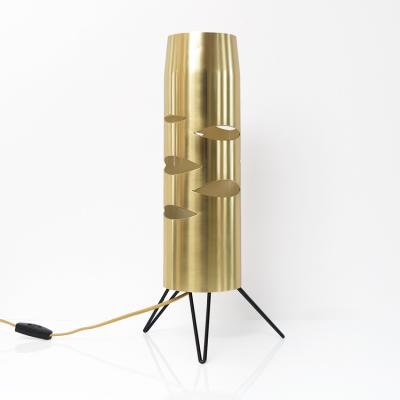 Scandinavian Modern cylindrical brass lamp with cutouts on a tripod base 