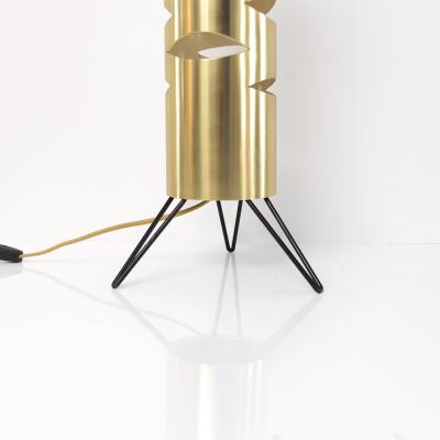 Scandinavian Modern cylindrical brass lamp with cutouts on a tripod base 