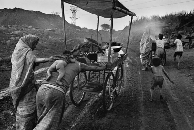 Sebasti o Salgado A family leaves an open cut coal mine with a cart used to bring food to workers