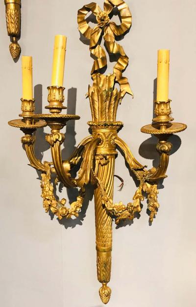 Set of Four Large Ornate Three Light Torch and Ribbon Form Wall Sconces