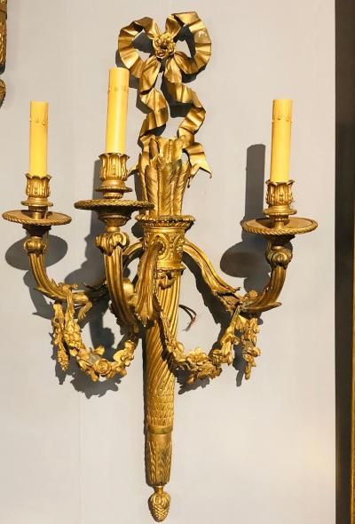 Set of Four Large Ornate Three Light Torch and Ribbon Form Wall Sconces