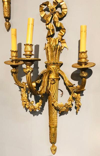 Set of Four Large Ornate Three Light Torch and Ribbon Form Wall Sconces