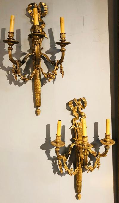 Set of Four Large Ornate Three Light Torch and Ribbon Form Wall Sconces