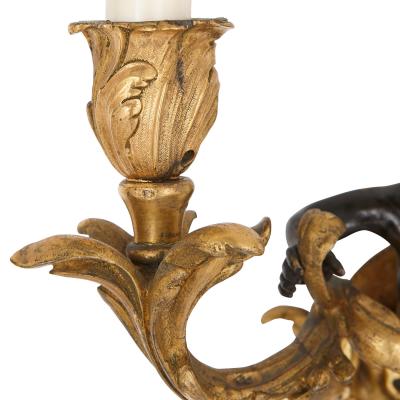 Set of four Rococo style patinated and gilt bronze sconces