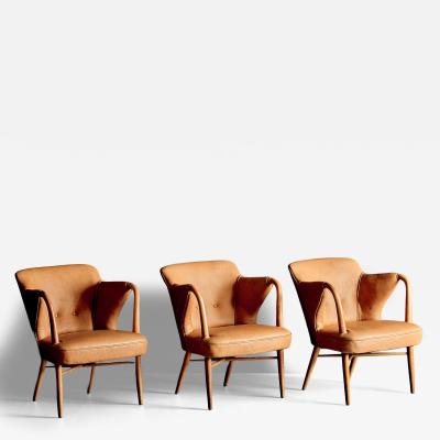 Set of three elegant Lounge Chairs upholstered in cognac Aniline Leather