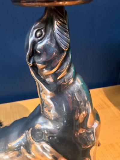 Silvered bronze illuminated sculpture representing a seal holding an onyx ball