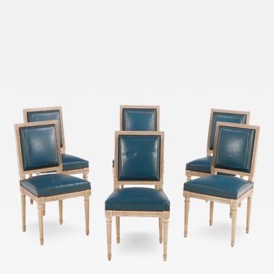 Six Louis XVI style painted and carved dining chairs in old blue leather C 1940