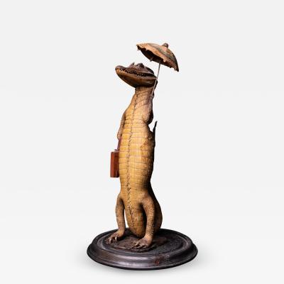 Small Alligator with Umbrella and Travel Case under a Glass dome