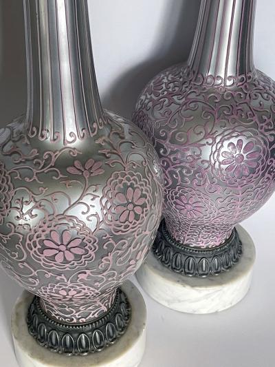 Tall pair of reverse silvered lamps with applied floral vine decoration