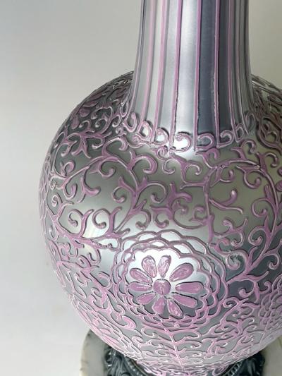 Tall pair of reverse silvered lamps with applied floral vine decoration