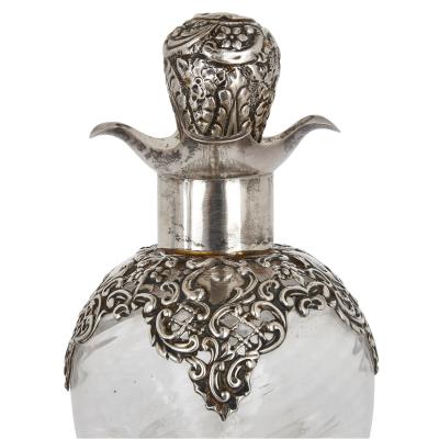Three English sterling silver and cut glass bottles