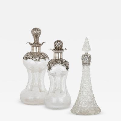 Three English sterling silver and cut glass bottles