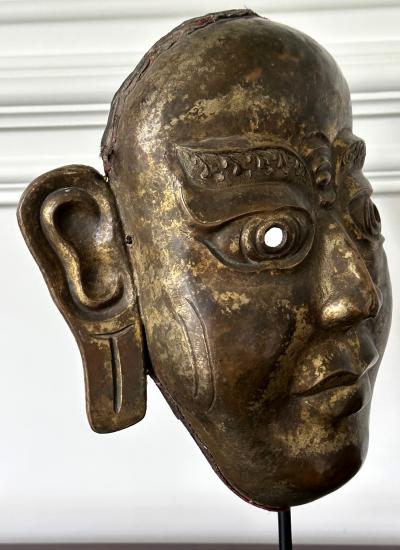 Tibetan Gilt Copper Alloy Mask on Display Stand