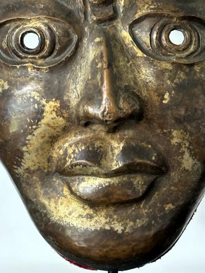 Tibetan Gilt Copper Alloy Mask on Display Stand