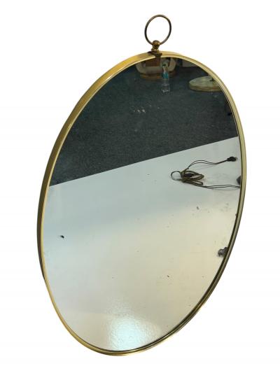 Tommi Parzinger MID CENTURY BRASS FRAMED OVAL MIRROR WITH RING IN THE MANNER OF TOMMI PARZINGER
