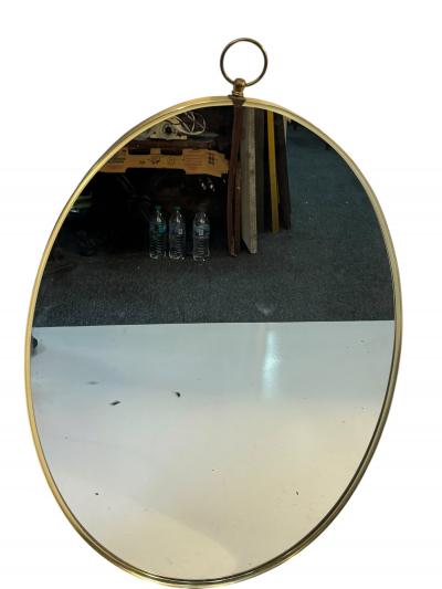 Tommi Parzinger MID CENTURY BRASS FRAMED OVAL MIRROR WITH RING IN THE MANNER OF TOMMI PARZINGER